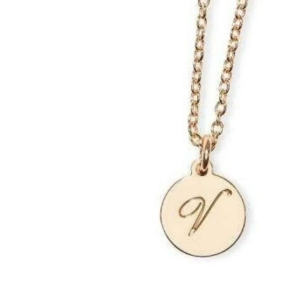 Nip luxury VS v in circle gold tone pendant with chain bottle charm.